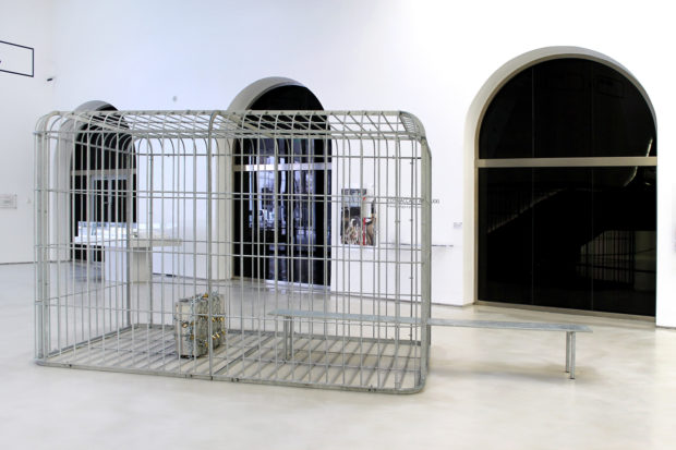 H.H.Lim, The cage the bench and the luggage, 2011, galvanized steel and aluminium suitcase with padlocks and chain, 484 x 216 x 228 cm, Collection of the artist, exhibition view at MAXXI, photo: Cecilia Fiorenza